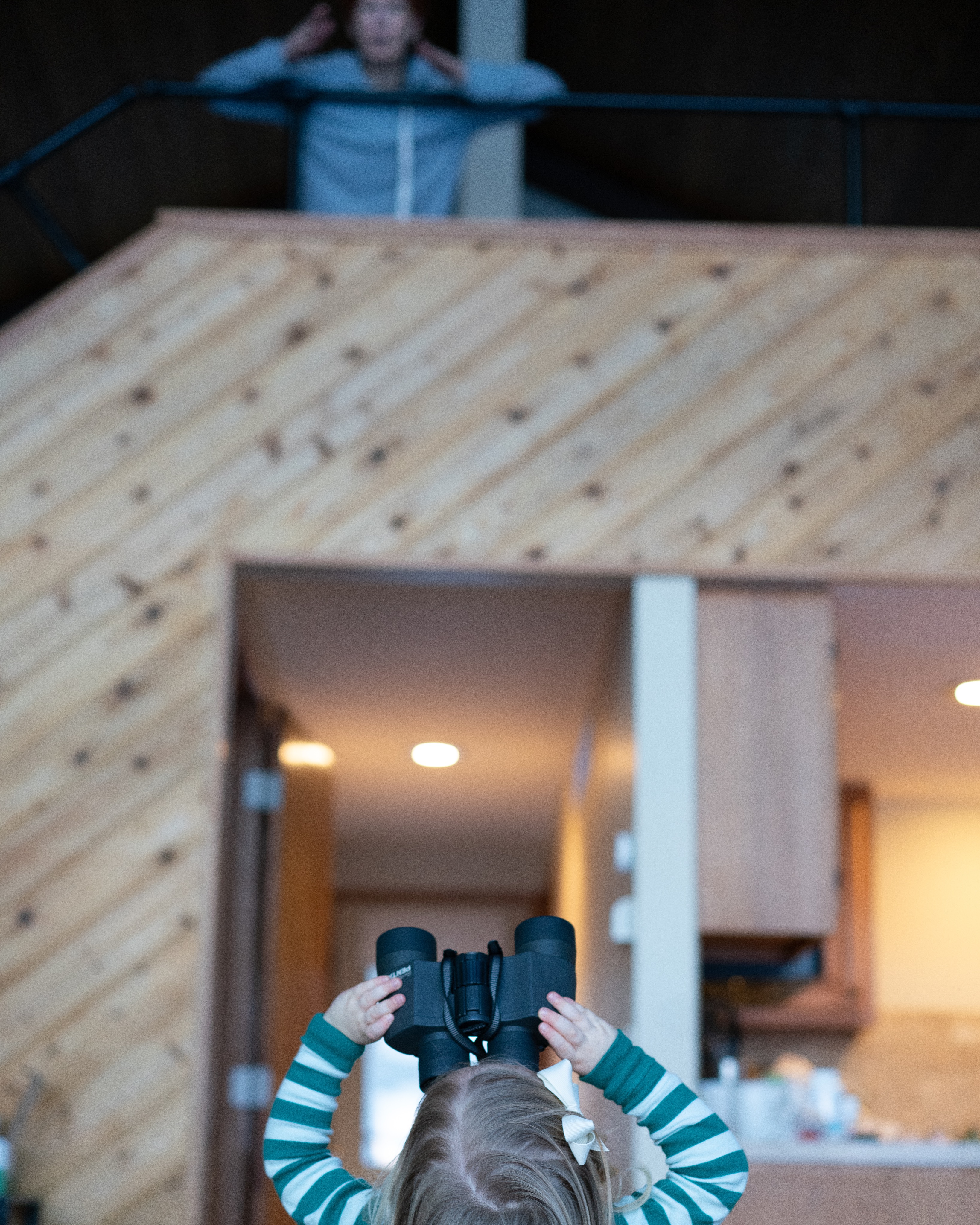 A toddler exploring the world through binoculars
